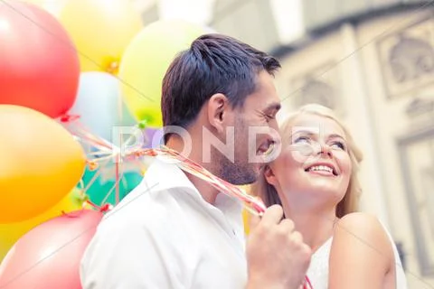 Happy couple with colorful balloons Stock Photos