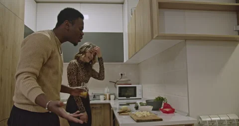 Happy Couple Dancing and Singing While Cooking Together in Their Modern Kitchen Stock Footage 313149184