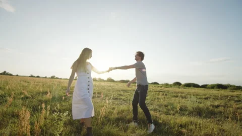 Happy couple dancing in field Video stock 220374458
