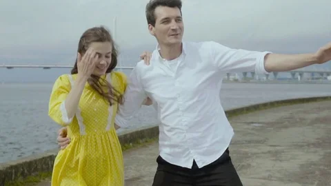Happy couple dancing quickstep dance at the embankment. Energetic dance Stock Footage 80924280