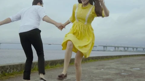 Happy couple dancing rock-n-roll dance at the embankment. Video stock 80387256