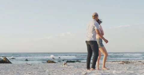 Happy couple dancing together at beach, in slow motion, with copy space Stock Footage 340964014