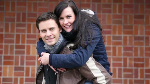 Happy couple doing piggy back ride Stock Footage 33079515