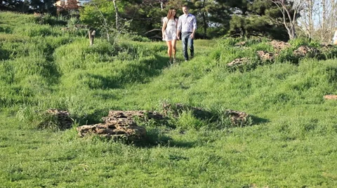 The happy couple down the slope in the Park Stock Footage 33953700