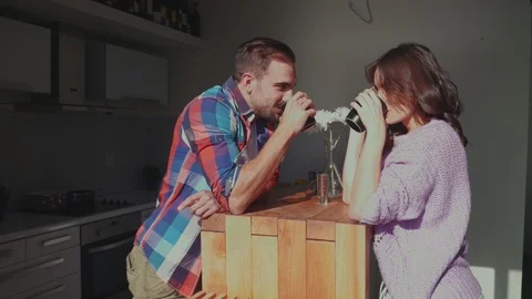 Happy couple drinking coffee in the kitchen Stock-Footage 99399323