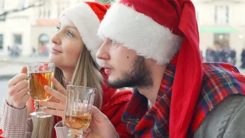 Happy couple drinking tea and wearing Santa's hats, steadycam shot Stock Footage 71579813