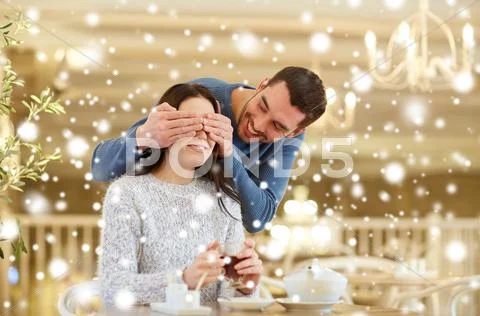 Happy couple drinking tea at cafe Stock Photos