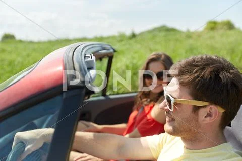 Happy couple driving in cabriolet car at country Stock Photos