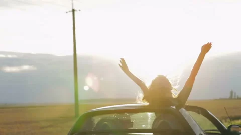 Happy Couple driving convertible car cabriolet on a background sunset Stock Footage
