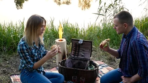 Happy couple eats sandwiches at the weekend rest Stock Footage 81756698