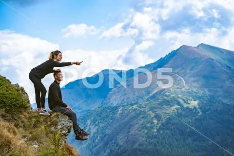 The happy couple enjoying on the beautiful cliff Stock Photos