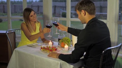 Happy Couple In The Evening For A Romantic Dinner, Clink Glasses And Drink Wine Vidéo 82786830