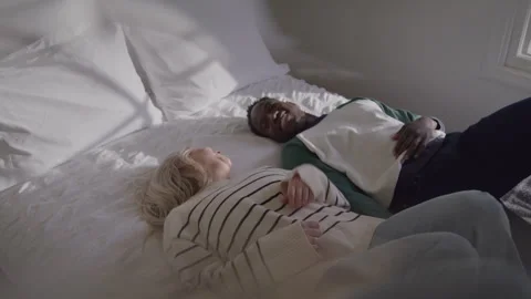 Happy Couple Falls Back On Bed Stock Footage 270295249