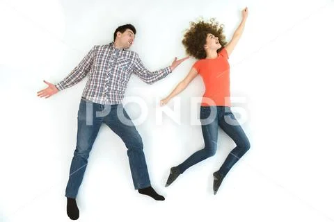 The happy couple gesture on the white floor. View from above Stock Photos