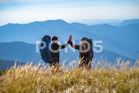The happy couple gesturing on the mountain Stock Photos