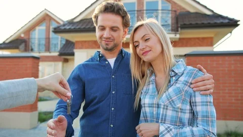 Happy couple getting a key to their new home from their realtor i the house 動画素材 78240040