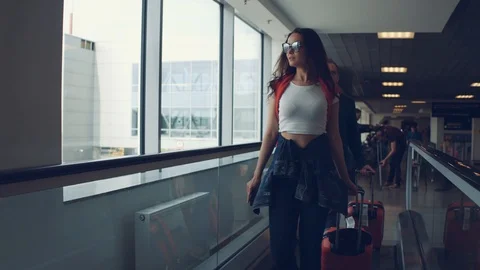 Happy couple going to the plane with red suitcases in airport. Stock Footage 108869015
