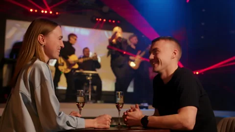 Happy couple having champagne while enjoying music show at restaurant Stock Footage 277034753