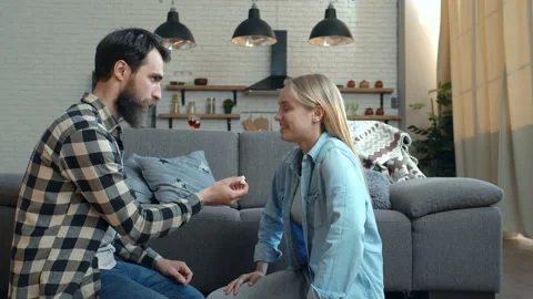 Happy couple having fun and joking at home. Guy throwing popcorn, while young wo Video stock 108667909