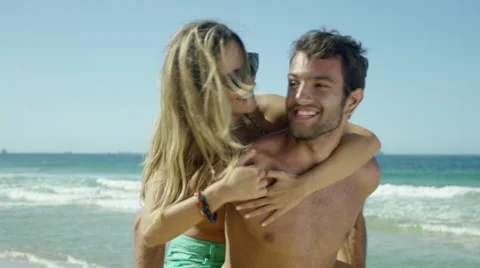 Happy couple having fun on beach Stock-Footage 49605493