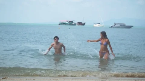 Happy couple having fun on the beach vacation during summer holiday in slow 스톡 동영상 84718164