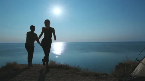 The happy couple having a fun in camping tent near the sea. slow motion Stock Footage 141648465