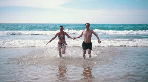 Happy Couple Having Fun on Ocean Waves Stock Footage 55450211