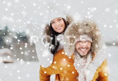 Happy couple having fun over winter background Stock Photos
