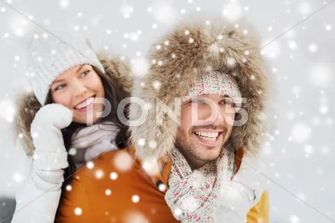 Happy couple having fun over winter background Stock Photos