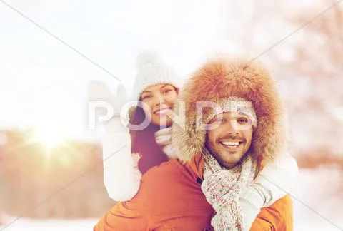 Happy couple having fun over winter background Stock Photos