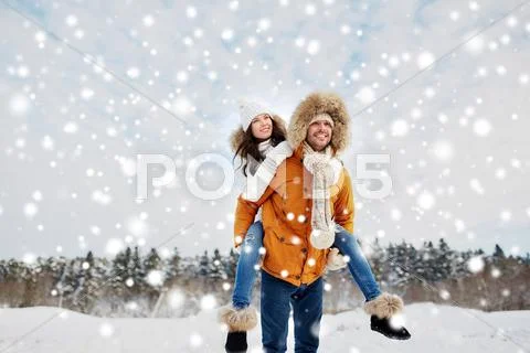 Happy couple having fun over winter background Stock Photos