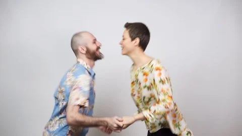 Happy couple having fun. Swing dancers wearing hawaiian shirts on white 動画素材 124843757