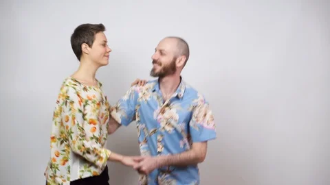 Happy couple having fun. Swing dancers wearing hawaiian shirts on white Stock Footage 124843850