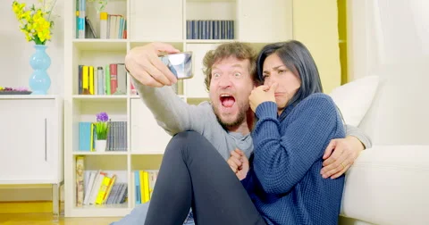 Happy couple having fun taking selfie pictures at home 4K Stock Footage 52807650