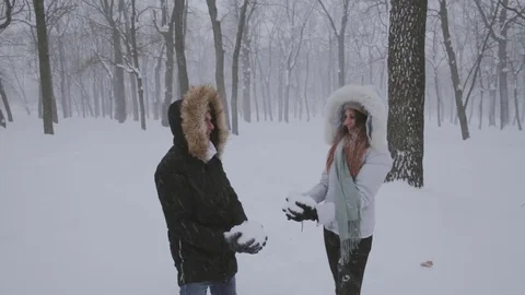 Happy couple having fun together throwing snow up Stock Footage 73352231