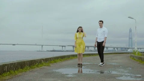 Happy couple having a good time at the embankment. They dancing on the paddles Stock Footage 80920719