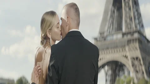 Happy couple having a good time in Paris at the Eiffel Tower. Action. Happy Stock Footage 224751379