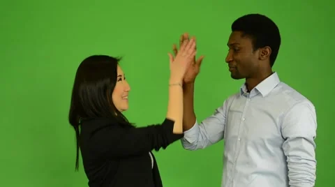 Happy couple high five and smile to camera - black man and woman - green screen Stock-Footage 45506615