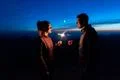 The happy couple holding firework sticks on the mountain background Photo