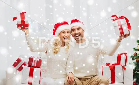 Happy couple at home with christmas gift boxes Stock Photos