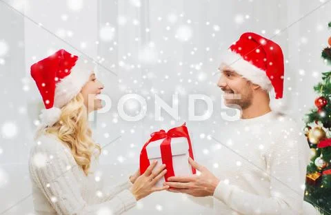 Happy couple at home with christmas gift box Stock Photos