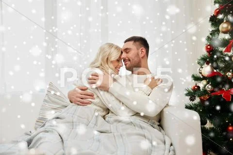 Happy couple at home with christmas tree Stock Photos