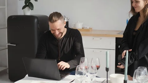 Happy couple in home kitchen work laptop.woman in black underwear Stock Footage 128115889