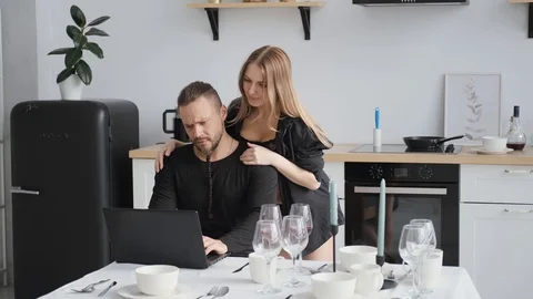 Happy couple in home kitchen work laptop.woman in black underwear Stock Footage 128116186