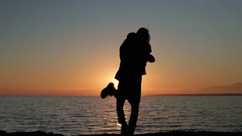 Happy couple hugging on beach at sunset Stock Footage 169147598