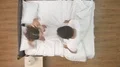 The happy couple jump in the bed. view from above 4k or 4k+ Resolution