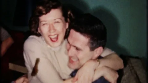 Happy couple kissing at house party 1950s vintage film home movie 4264 Stock Footage