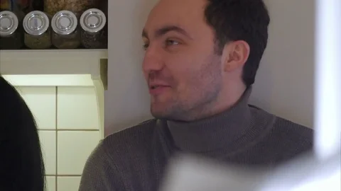 Happy couple on the kitchen washing vegetables to prepare healthy dinner and Stock Footage