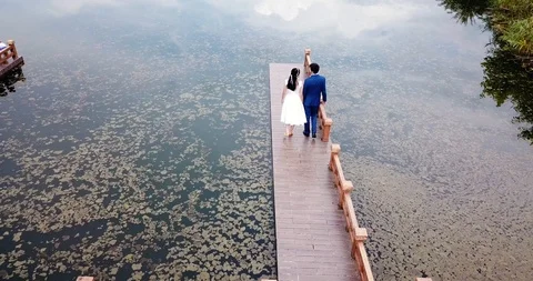 Happy couple by the lake Stock Footage 99593387