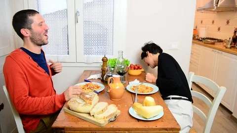 Happy couple laughing while eats traditional italian lunch together 스톡 동영상 122295749